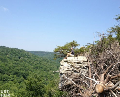 Kurt Uhlir sitting on cliff at Bucks Pocket State Park in Alabama
