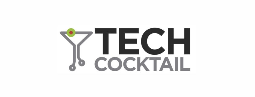 Logo for "TECH COCKTAIL" featuring bold black and gray text. To the left, a martini glass formed from circuit board lines symbolizes healthy communications—central to success—with a green and red olive garnish at the top. White background.
