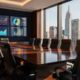 A modern conference room with a large wooden table and black chairs, wall-mounted screens displaying charts to measure impact and Demand Gen ROI, and floor-to-ceiling windows offering views of a city skyline under a clear sky.